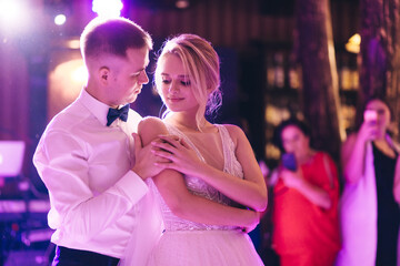 beautiful couple have just got married and are dancing their first dance