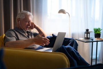Senior male speaking with family online