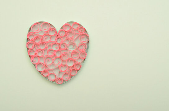 A paper heart on light green background