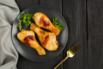 Top view of fried chicken legs in the black plate with copy space