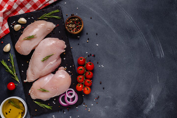 Raw chicken fillet with spices and herbs.