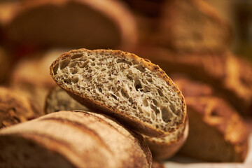 Freshly baked aromatic bread. Bread in a cut. Fragrant pastries close-up. Homemade sourdough bread. Wheat rye flour. Handmade. Food trends. Various types of fresh bread as a background.

