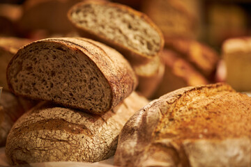 Freshly baked aromatic bread. Bread in a cut. Fragrant pastries close-up. Homemade sourdough bread....