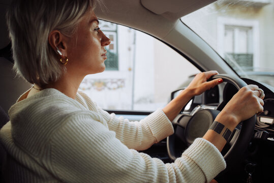 Inside View Of A Blond Woman Driving A Car