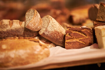 Freshly baked aromatic bread. Bread in a cut. Fragrant pastries close-up. Homemade sourdough bread. Wheat rye flour. Handmade. Food trends. Various types of fresh bread as a background.

