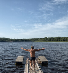 Fototapeta na wymiar wooden footbridge on a lake in Finland.