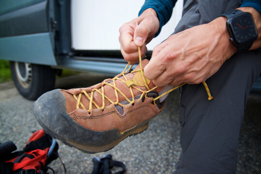 Hiker tying his mountain shoes in Canfranc Valley, Pyrenees in Spain.