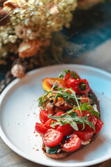 Appetizing bruschetta on a white plate. restaurant server