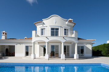 Exterior of luxury Holiday Villa with blue sky and beautiful swimming pool