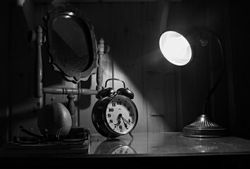 Old vintage alarm clock on the night table, Black and White