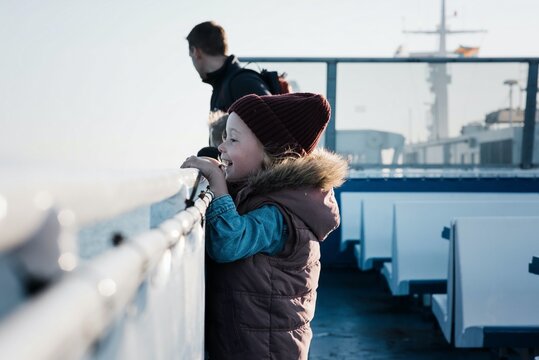 young girl looking excited whilst travelling on a ferry boat