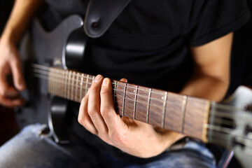 Fototapeta premium musician plays electric guitar, concept of rock, metal music. Selective focus