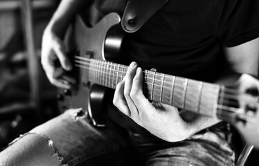 Fototapeta na wymiar male guitarist playing electric guitar. black and white
