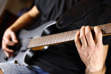 Fototapeta na wymiar guitarist playing guitar, hands closeup