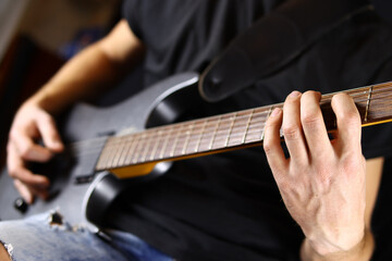 Fototapeta premium guitarist playing guitar, hands closeup