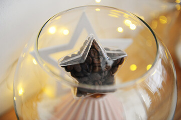 Star filled with coffee beans on decorative Christmas tree made of pour over origami dripper