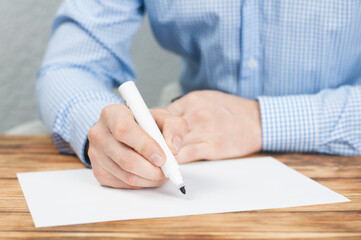 Blank sheet. The hand of a businessman writes. Marker in hand