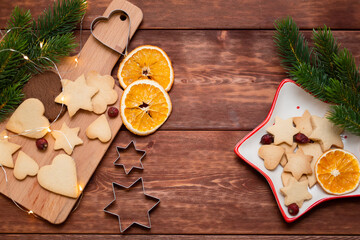 tart with berries, cookies on the wood background, top view