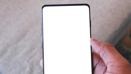 close up on hand holding modern mobile phone with blank empty white screen.