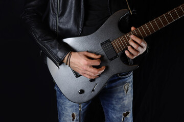 Fototapeta na wymiar musician guitarist in a leather jacket playing electric guitar