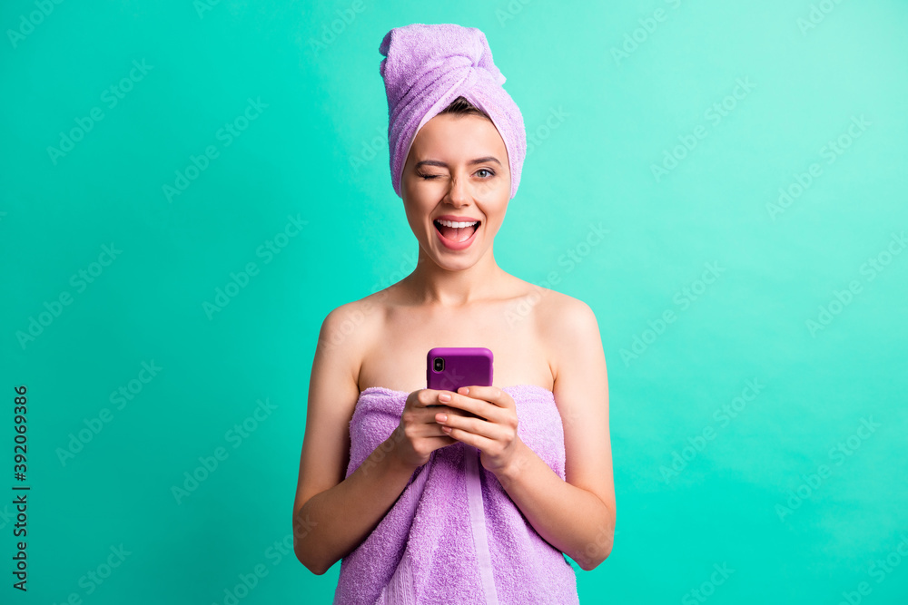 Sticker Photo of beautiful lady wink eye hold telephone hands good mood wear violet towels isolated teal color background