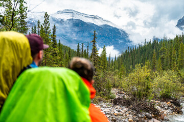 Hikers Observing a Fresh Layer of Snow on Nearby Mountains