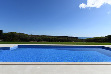 Section of a large luxury swimming pool in the garden of a private house with views across the National Park