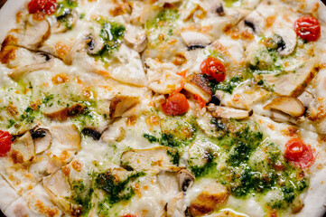 pizza with chicken, mozzarella, olives and basil top view with copy space