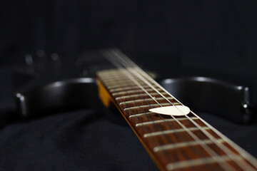 Fototapeta premium pick on the strings of the electric guitar. Selective focus