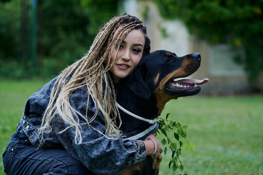 Young woman with blonde colored braided hair wearing a denim jac