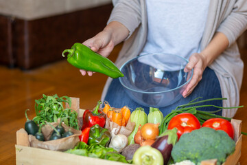 Woman selecting fresh vegetables for lunch preparation