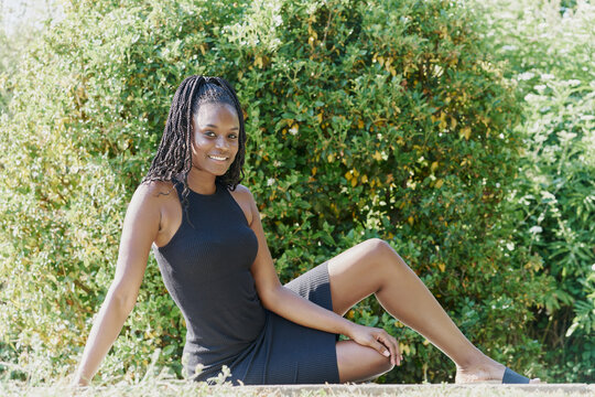 Portrait of a beautiful black woman drinking sitting on the floor