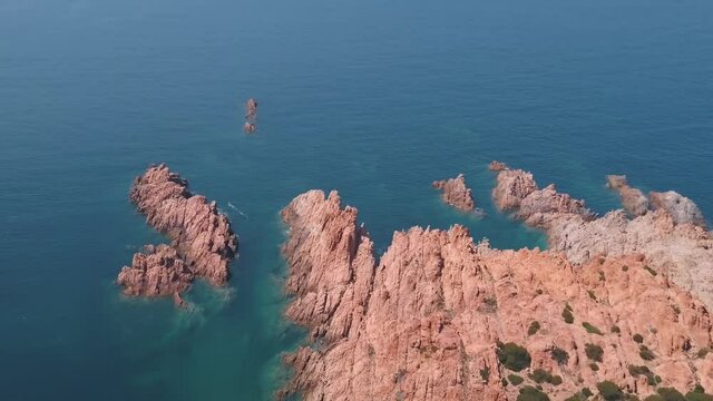Aerial view of a reddish remote reef near Isola Rossa, Sardinia, Italy.