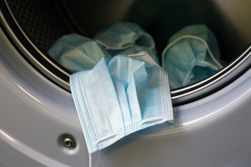 Obraz premium Closeup of medical masks in the washing machine for recycling