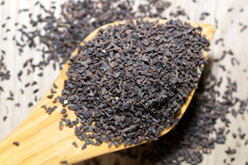 wild rue seeds, Peganum harmala in the wooden  spoon