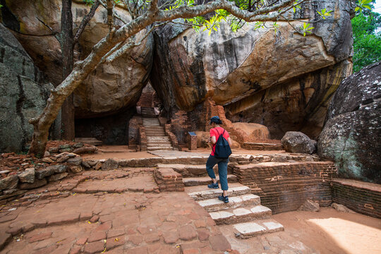 woman climbing up the stairs towards the rock fortress of Sigiriya