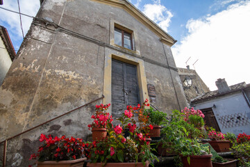 The Museum at Calcata vecchia,There is a wooden sign written in Italian in front of the door that says Museum of peasant civilization and Free admission, free entry.