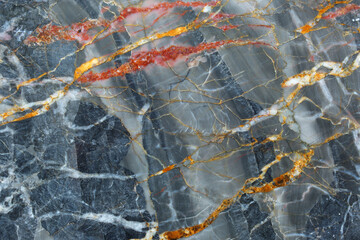 abstract yellow, red and white patterned structure of dark gray marble (Gold Russia) texture or background for design.