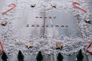 Christmas decoration on rustic wooden background with Marry Christmas text, low angle of view