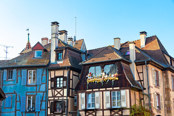 Fototapeta premium Traditional Alsatian half-timbered houses and river Lauch in Petite Venise or little Venice, old town of Colmar, decorated and illuminated at christmas time, Alsace, France
