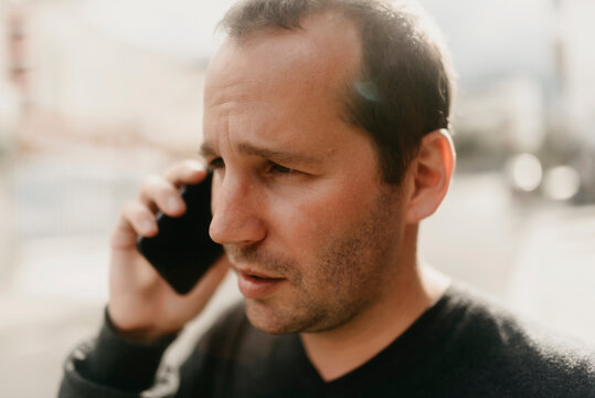 a  man talking on the phone in the street