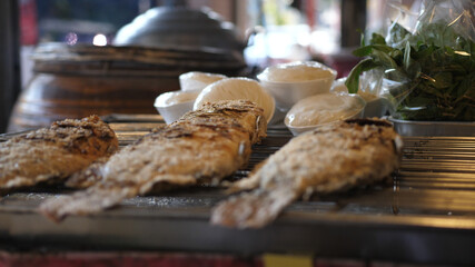 Fried fish on the grill on the street market.