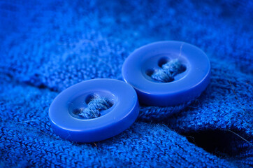 Two blue buttons of a vibrant blue jumper