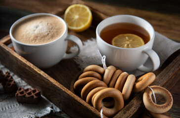 
Tea, coffee and cookies on a wooden table
