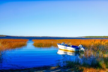 Boat resting on scenic lake.. 