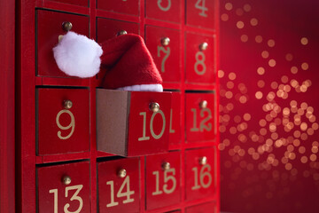 Red wooden Advent calendar with surprise for Christmas