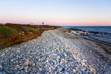 Point Judith Lighthouse and beach over coloful sky.