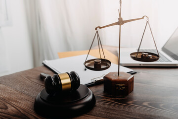 Business and lawyers discussing contract papers with brass scale on desk in office. Law, legal...