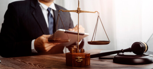 justice and law concept.Male judge in a courtroom on wooden table and Counselor or Male lawyer...