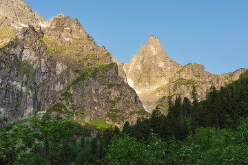 summer in the Polish High Tatras with a tourist girl walking near the mountain lakes.